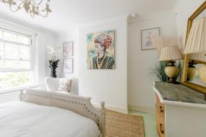 a bedroom with a bed and a painting on the wall at Writers Retreat in the heart of Ashford Town in Kent