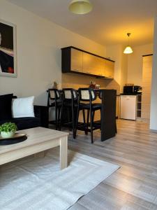 a living room with a couch and a table at Апартамент Рафаела-Мартина-Регнум in Bansko
