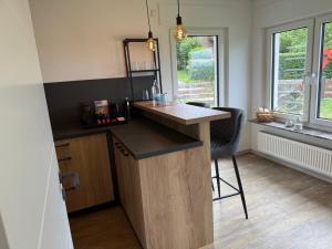a kitchen with a counter and a bar with a window at Pro Home FeWo Hiddenhausen in Hiddenhausen