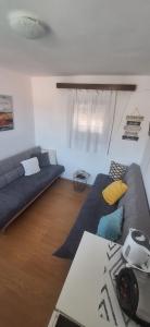 a living room with two couches and a table at Apartman Mare BP in Dolac