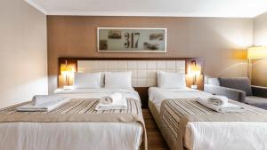 Postel nebo postele na pokoji v ubytování Kent Hotel