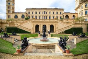 a fountain in front of a building with statues at Self Catering Appartment 1 bedroom 2 double beds in East Cowes