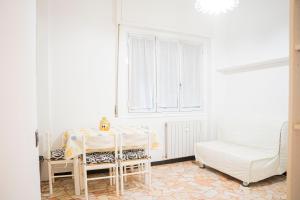 a white room with a table and a chair at 039C- Casa Residenziale a Lavagna a 5 minuti dal mare in Lavagna +27 photos