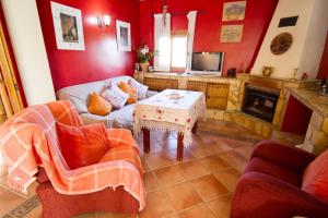 a living room with a couch and a table at Casa Rural Cortijos San Jose in Iznájar