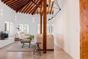 a living room with a couch and a table at iloftmalaga Premium Centro Histórico in Málaga