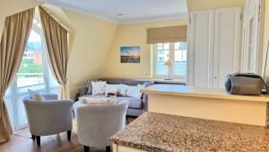 a living room with a couch and a table at Syltrose Whg 1b in Westerland (Sylt)