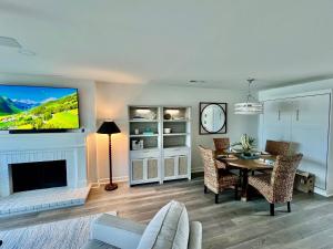 a living room with a table and a tv on a wall at 1935 Bohicket Marina in Seabrook Island +31 photos