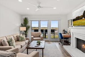 a living room with a couch and a fireplace at 1935 Bohicket Marina in Seabrook Island