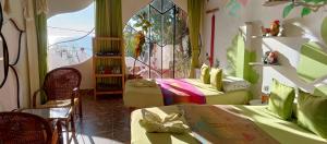 a room with two beds and a window at HOSTAL PIEDRA ANDINA - Copacabana in Copacabana