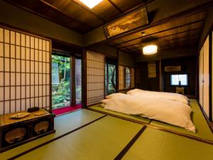 Voodi või voodid majutusasutuse Temple Hotel Takayama Zenkoji toas