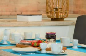 a table with plates and cups and food on it at Marina Loft in Kappeln +16 photos