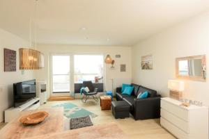 a living room with a couch and a tv at Marina Loft in Kappeln