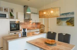 a kitchen with a table with a bowl of bread on it at Marina Loft in Kappeln