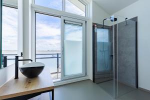 a bathroom with a shower and a bowl on a table at Vakantiewoning aan het water - met 4 balkons - Vista Maris - Nr 30 in Sint Annaland