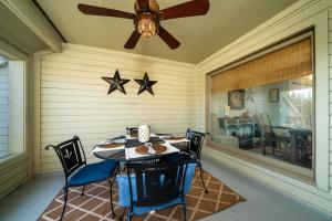 a dining room with a table and two stars on the wall at 1644 Courtside Villa in Seabrook Island