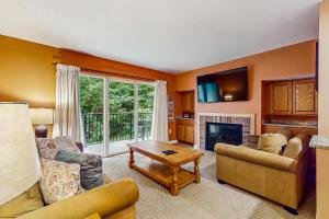 a living room with two couches and a fireplace at Mountainside 75 in Warren