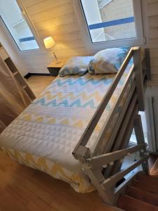 a bunk bed in a room with a window at la petite maison in Granville