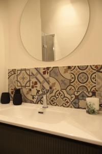 a bathroom with a sink and a mirror at Alloggio turistico Il punto di vista in Tuscania