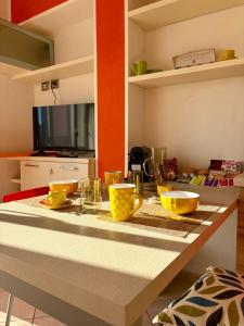 a kitchen with a counter with yellow bowls on it at Monolocale Eco del Mare in Portoferraio
