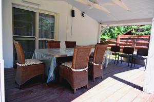 a patio with a table and chairs on a deck at Radawa domek in Radawa