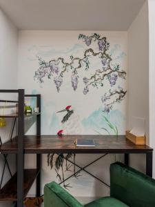 a desk in a room with a painting on the wall at Aphrodite Apartment in Athens