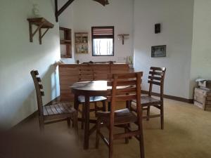 a dining room with a wooden table and chairs at The Village Tangalle in Tangalle