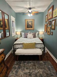 a bedroom with a bed and a ceiling fan at Historic Farmhouse - Tranquil Nature Escape in Hondo