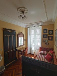 a living room with a tv and a couch at Affittacamere Rilke in Trieste +23 photos