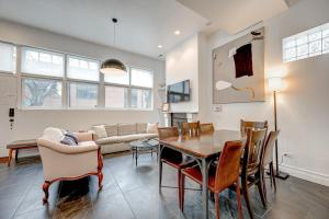 a living room with a table and a couch at Large Condo with Outdoor Deck in Historic Chicago District home in Chicago