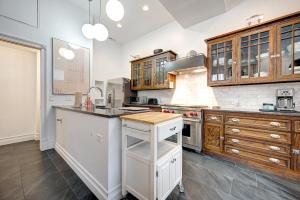 a large kitchen with wooden cabinets and a counter at Large Condo with Outdoor Deck in Historic Chicago District home in Chicago