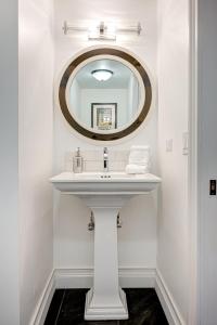 a bathroom with a white sink and a mirror at Large Condo with Outdoor Deck in Historic Chicago District home in Chicago +17 photos
