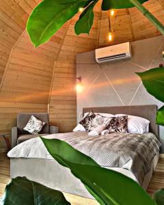 a bedroom with a bed in a wooden ceiling at Forest Glamp & Jacuzzi in Zakopane