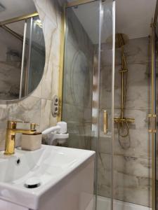 a bathroom with a sink and a shower at Forest Glamp & Jacuzzi in Zakopane