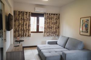 a living room with a couch and a window at Hotel Fazenda Portal de Gravatá in Gravatá
