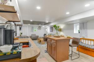 a kitchen and living room with a counter and a table at Logan Square Urban Oasis: 2 Mi to Local Hotspots! in Chicago