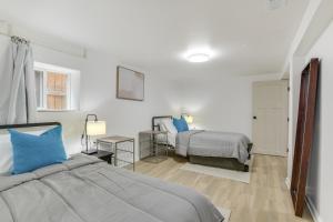 a bedroom with two beds with blue pillows at Logan Square Urban Oasis: 2 Mi to Local Hotspots! in Chicago