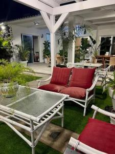 a patio with two chairs and a red couch at House with 2 Bedrooms in Los Llanos de Aridane in Los Llanos de Aridane +17 photos