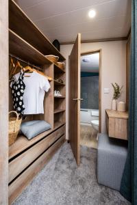 a bathroom with a walk in closet and a toilet at Hot Tub Lodge, Victory Liberte 104 in St. Andrews