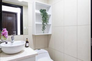 a white bathroom with a sink and a toilet at Puerto Santa Ana Luxury Suites Guayaquil in Guayaquil +112 photos
