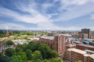 an aerial view of a city with tall buildings at Modern Stylish Apartment Manchester in Manchester