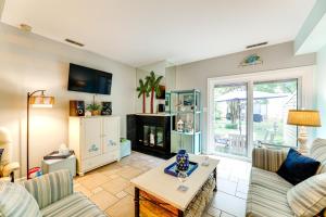 a living room with a couch and a fireplace at about 1 Block to Bethany Beach, Retreat with Pool Access in Bethany Beach