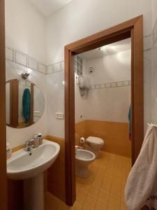 a bathroom with a sink and a toilet at Casa Vacanza Alba Dorata in Otranto
