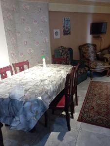 a dining room with a table and chairs and a room at sidi bashr el tram street ali abi bash in Banī Ghālib