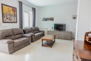 a living room with a couch and a coffee table at Casa Carmen in Stazione di Paestum