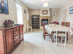 a dining room with a table and a fireplace at Holiday Home Le Brieux by Interhome in Quimper