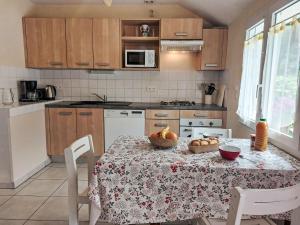 a kitchen with a table with a tablecloth on it at Holiday Home Le Brieux by Interhome in Quimper +27 photos
