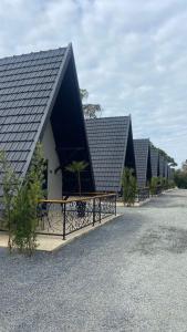 a row of black roofs on a row of houses at Hotel Villa Verde by Easy Hotéis in São Bento do Sul