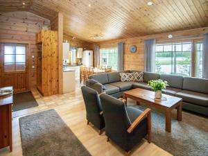 a living room with a couch and a table at Holiday Home Kaunotar by Interhome in Savitaipale