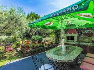 a patio with a table and an umbrella at Apartment Lorena by Interhome in Buje