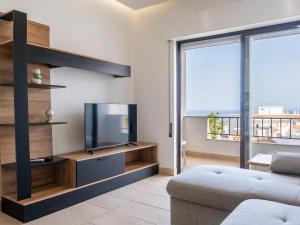 a living room with a tv and a couch at Neptuno Sea View Apartment - Sea View & Pool & Top Location in Albufeira